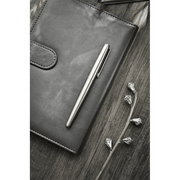 HONGDIAN 517S Gun Metal Fountain Pen with Closed Cap Showed on Gray Colour Diary with Wooden Background