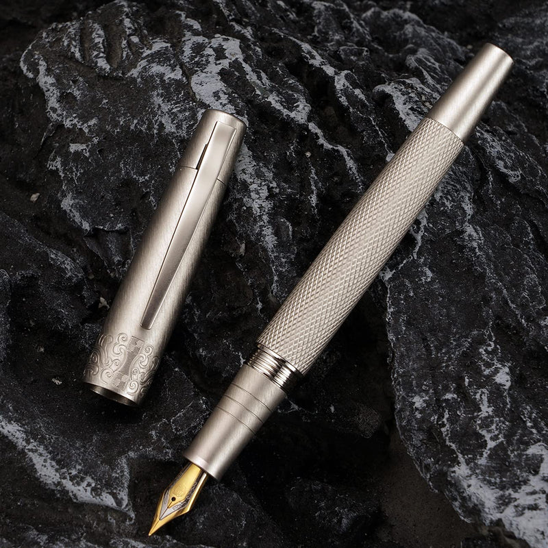HONGDIAN 6013 Gun Metal Fountain Pen Open Cap Display and Cap Beside Pen with Black Stone in Background 
